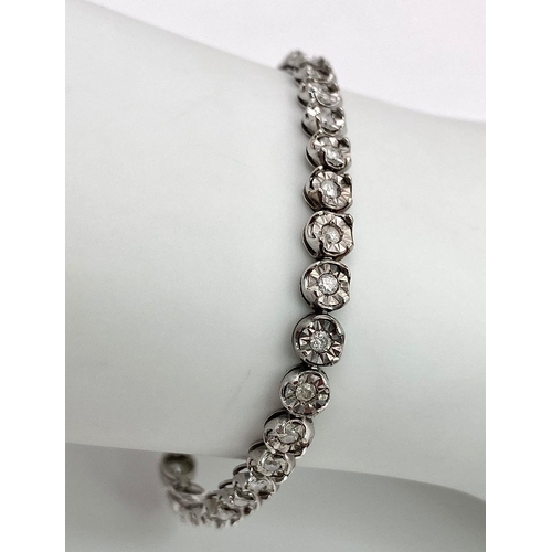 18 - A White Gold Diamond Necklace and Tennis Bracelet. Necklace - 10k white gold with slightly graduated... 