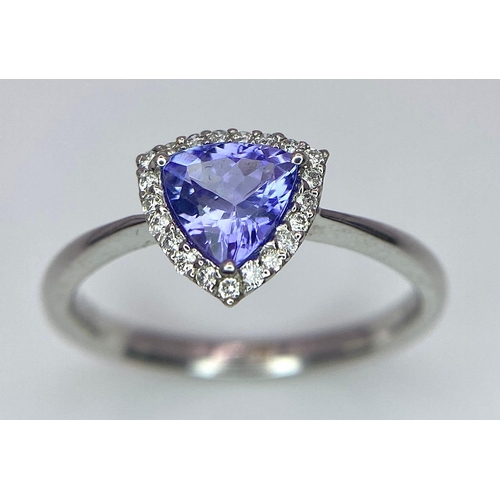 232 - A 9K White Gold Tanzanite and Diamond Ring. Trillion cut tanzanite with a diamond surround. Size N. ... 