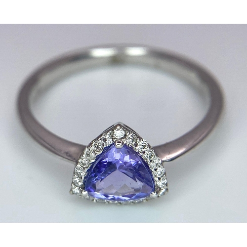 232 - A 9K White Gold Tanzanite and Diamond Ring. Trillion cut tanzanite with a diamond surround. Size N. ... 