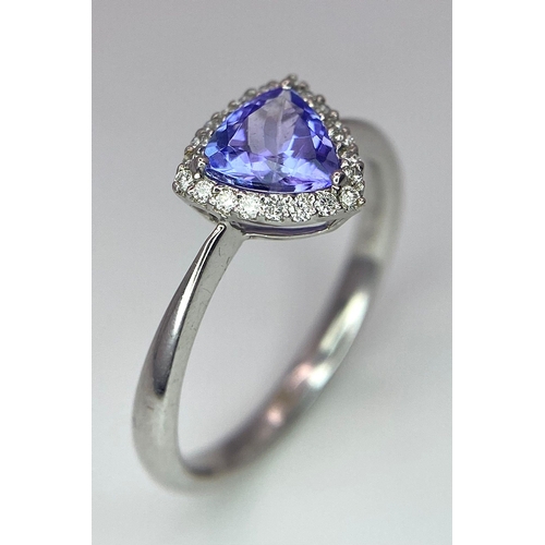 232 - A 9K White Gold Tanzanite and Diamond Ring. Trillion cut tanzanite with a diamond surround. Size N. ... 