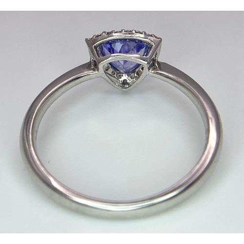 232 - A 9K White Gold Tanzanite and Diamond Ring. Trillion cut tanzanite with a diamond surround. Size N. ... 