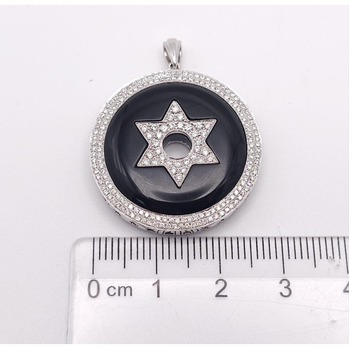 347 - An 18K White Gold Black Onyx and Encrusted Diamond Star Pendant. Rich black onyx with two different ... 