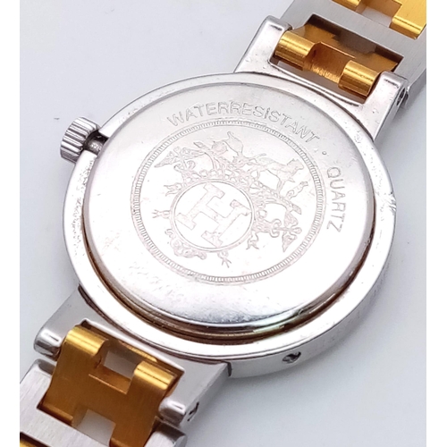 403 - A Designer Hermes Quartz Ladies Watch. Two tone stainless steel bracelet and case - 25m. White dial ... 