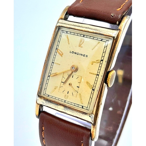 438 - A Vintage Mechanical Longine Gents Watch. Brown leather strap. Gold filled tank case - 23mm. Gold to... 