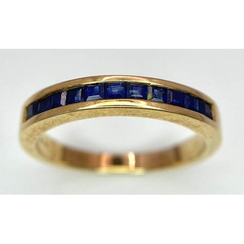 348 - 9K YELLOW GOLD SAPPHIRE CHANNEL SET BAND RING, WEIGHT 2.6G, SIZE M 1/2