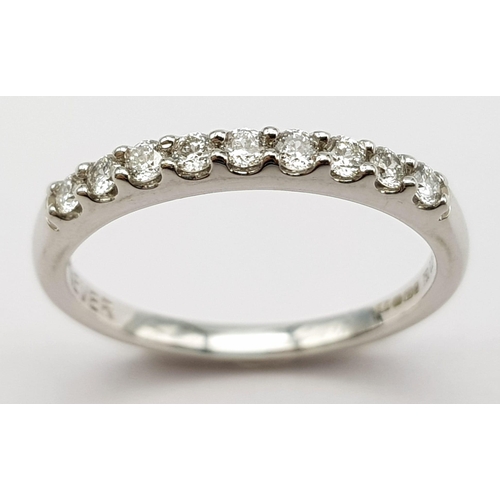 382 - An 18K White Gold and Diamond Half-Eternity Ring. 0.20ctw. Comes with a certificate. Size K. 2.2g we... 