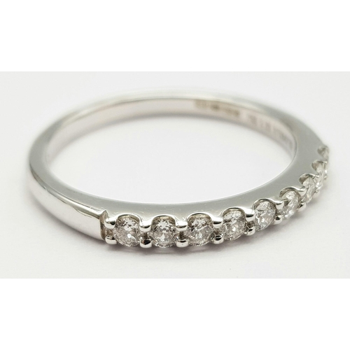 382 - An 18K White Gold and Diamond Half-Eternity Ring. 0.20ctw. Comes with a certificate. Size K. 2.2g we... 