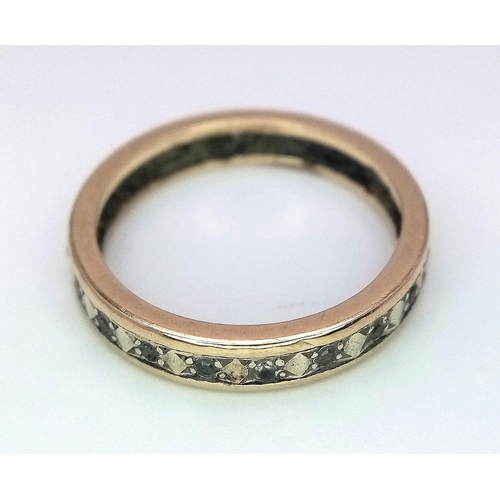 516 - A 9 K yellow gold eternity ring with cubic zirconia, size: N, weight: 2.4