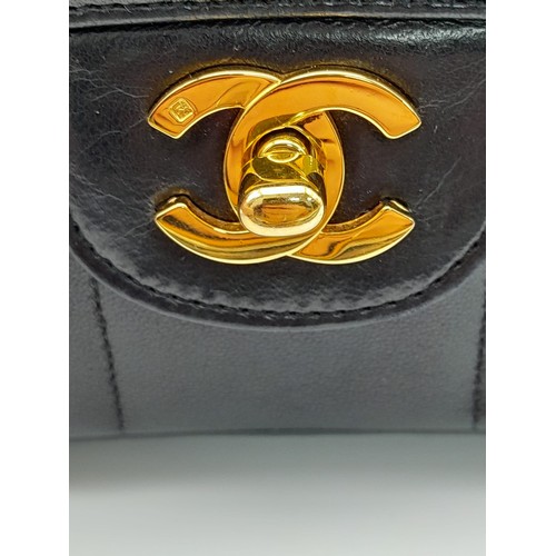 1 - An Early 1990s Chanel Mademoiselle Classic Flap Chain Bag. Black lambskin leather. Gold plated hardw... 