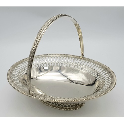 65 - An Antique Sterling Silver Oval Swing Handled Cake/Bread Basket. Pierced geometric and beaded decora... 