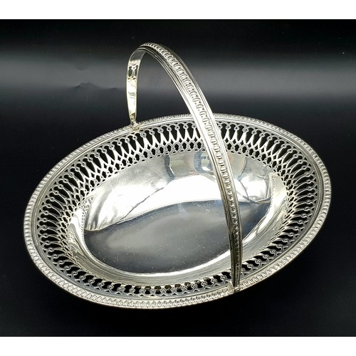 65 - An Antique Sterling Silver Oval Swing Handled Cake/Bread Basket. Pierced geometric and beaded decora... 