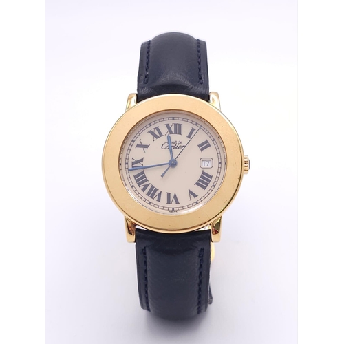 410 - A Must De Cartier Gold Plated Silver Quartz Ladies Watch. Black leather strap. Gold plated silver ca... 