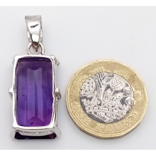 614 - An Amethyst Rectangular Step Cut Pendant set in 925 Sterling silver. 7g weight. 20ct Amethyst. 4cm. ... 