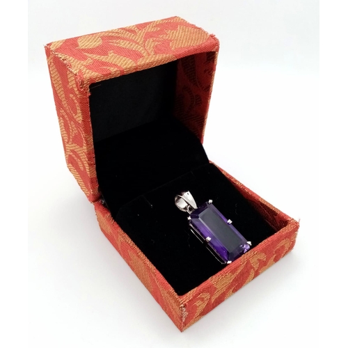 614 - An Amethyst Rectangular Step Cut Pendant set in 925 Sterling silver. 7g weight. 20ct Amethyst. 4cm. ... 