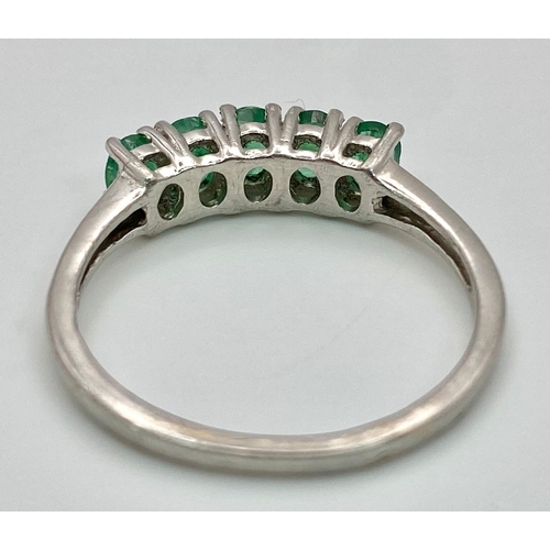 895 - A Vintage 5 Stone Sterling Silver Emerald Ring Size Q. The ring is set with five 4mm Oval Cut Emeral... 