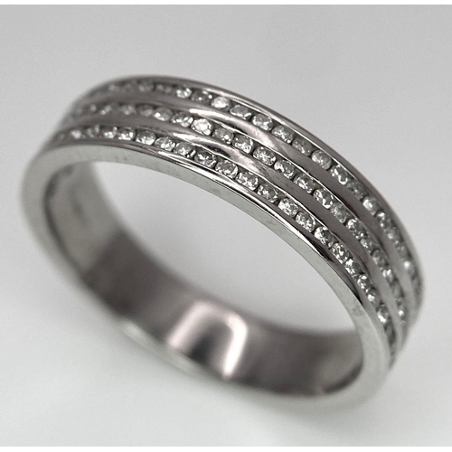 561 - An 18 K white gold ring with three diamond bands (0.33 carats), size: K, weight: 3.7 g.