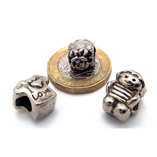 762 - Three sterling silver charms, total weight: 9.5 g.