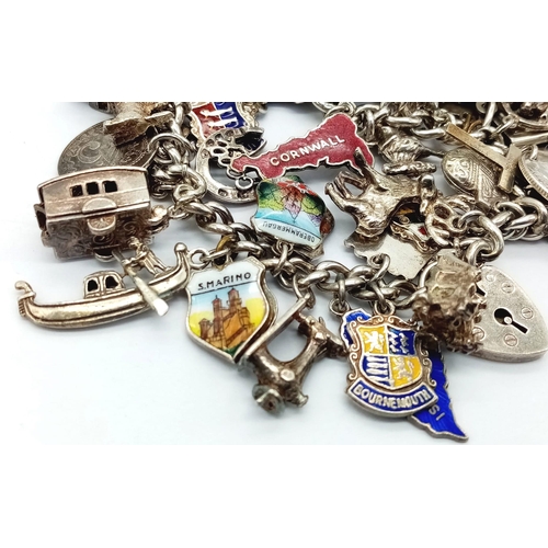 955 - A vintage sterling silver multiple charms chunky bracelet include famous landmarks, etc. Total weigh... 