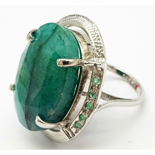 593 - A Brazilian Oval Cut Emerald Ring set in 925 Sterling silver. W-16.80g. 65ct emerald. Size O. Ref: V... 