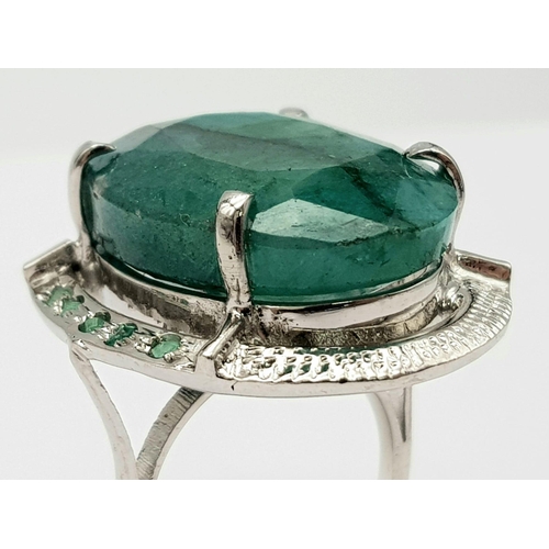 593 - A Brazilian Oval Cut Emerald Ring set in 925 Sterling silver. W-16.80g. 65ct emerald. Size O. Ref: V... 