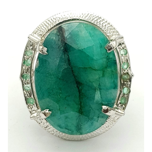 593 - A Brazilian Oval Cut Emerald Ring set in 925 Sterling silver. W-16.80g. 65ct emerald. Size O. Ref: V... 