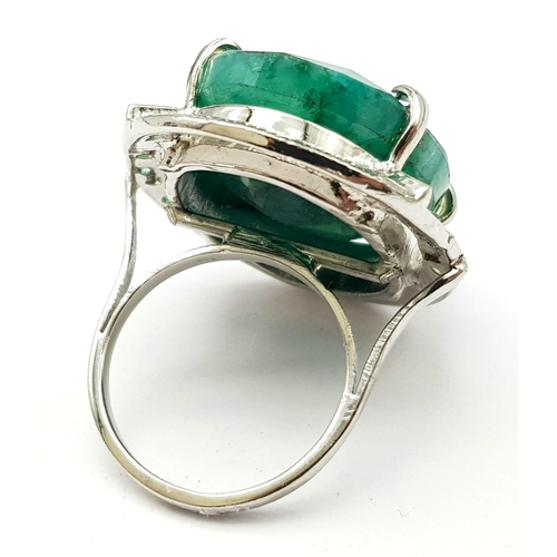 593 - A Brazilian Oval Cut Emerald Ring set in 925 Sterling silver. W-16.80g. 65ct emerald. Size O. Ref: V... 