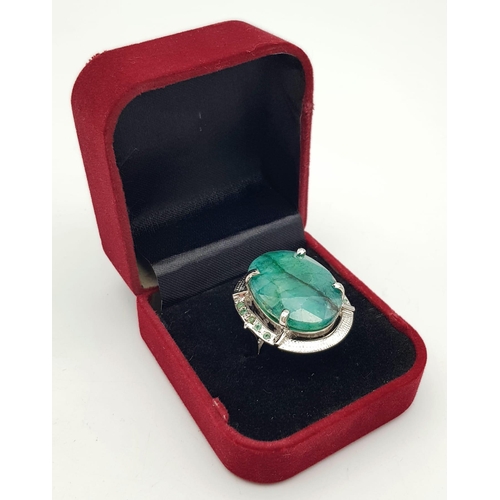 593 - A Brazilian Oval Cut Emerald Ring set in 925 Sterling silver. W-16.80g. 65ct emerald. Size O. Ref: V... 