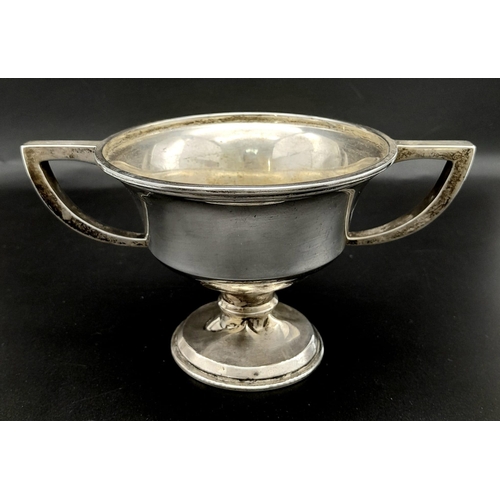 764 - An Antique Small Sterling Silver Two Handled Trophy. Hallmarks for Birmingham 1918. 9cm tall. 121g w... 