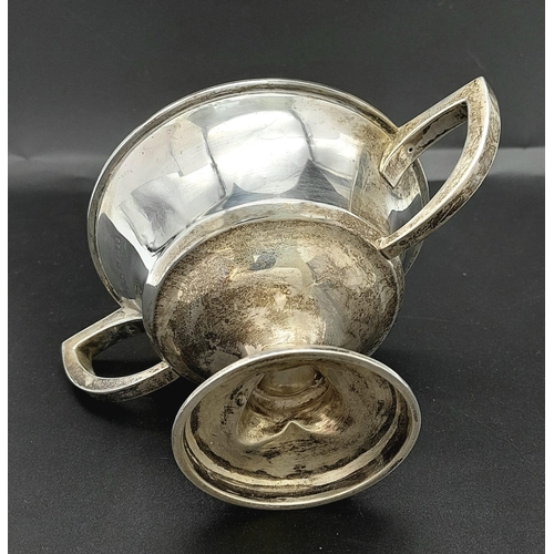 764 - An Antique Small Sterling Silver Two Handled Trophy. Hallmarks for Birmingham 1918. 9cm tall. 121g w... 