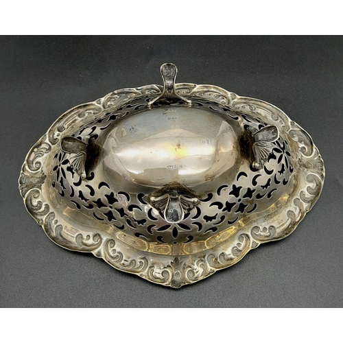 821 - A vintage sterling silver bonbon dish with scrolled feet and pierced floral patterns. Total weight 8... 