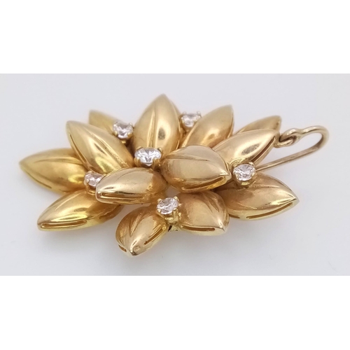 571 - A 9K Yellow Gold (tested) and Diamond Decorative Floral Brooch. Six brilliant white zircons amongst ... 