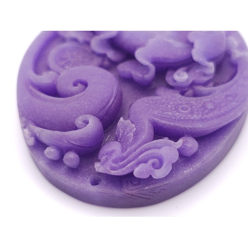 641 - A Beautiful Dark Lavender Jade Oval Pendant. Decorative floral decoration. 6cm.