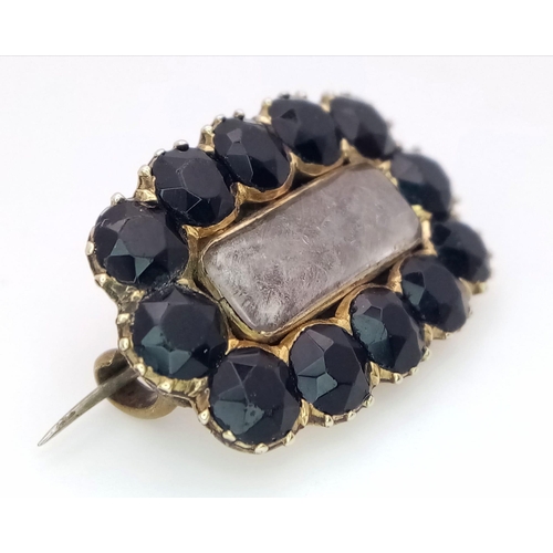 620 - An Antique Mid Karat Gold and Sapphire Memorial Brooch/Pendant. 12 round cut sapphires. 25mm x 17mm.... 