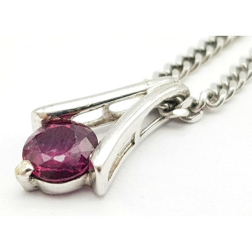 649 - A 9K White Gold Ruby Pendant on a 9K White Gold Small Curb Link Necklace. 15mm pendant. 44cm necklac... 