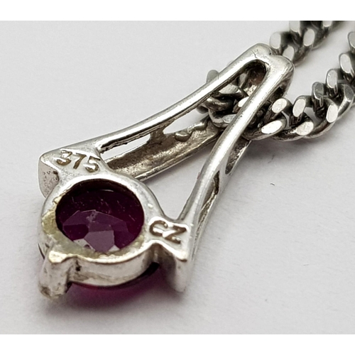 649 - A 9K White Gold Ruby Pendant on a 9K White Gold Small Curb Link Necklace. 15mm pendant. 44cm necklac... 