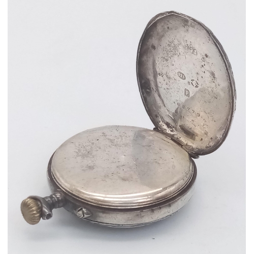 675 - A SILVER MINITURE POCKET WATCH FOR SPARES OR REPAIR.