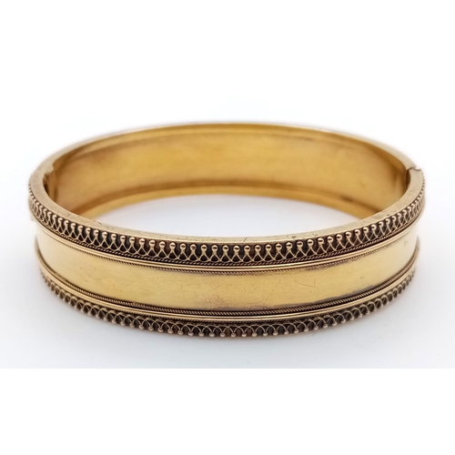 713 - A 9K GOLD BACK AND FRONT HINGED BANGLE .   13.4gms