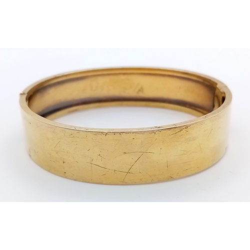 713 - A 9K GOLD BACK AND FRONT HINGED BANGLE .   13.4gms