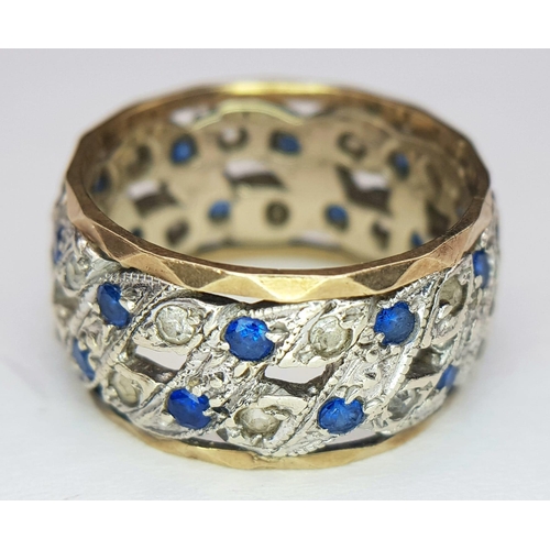 750 - A 9K WHITE AND YELLOW GOLD BAND RING WITH PIERCED SIDES AND CONTAINING A SAPPHIRE AND DIAMOND PATTER... 