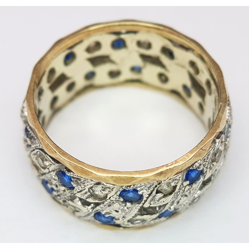 750 - A 9K WHITE AND YELLOW GOLD BAND RING WITH PIERCED SIDES AND CONTAINING A SAPPHIRE AND DIAMOND PATTER... 