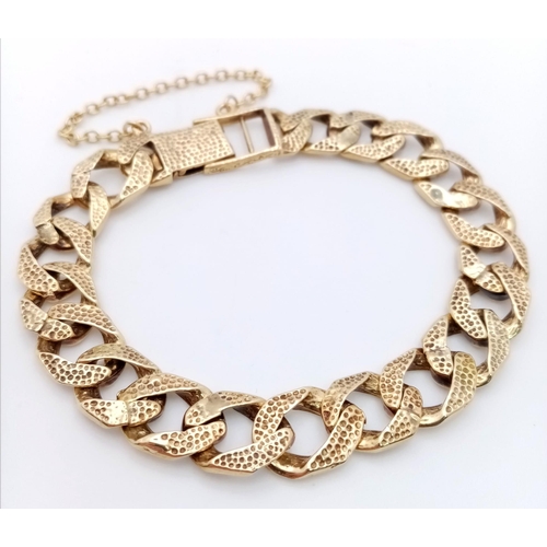 758 - A CHUNKY 9K GOLD BRACELET WITH BARKED FINISH AND SAFETY CHAIN .29.8gms    20cms