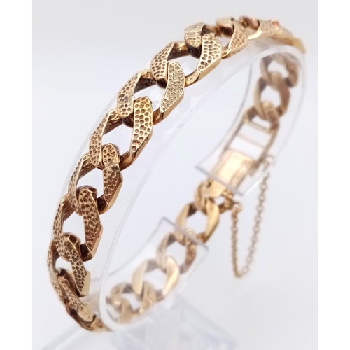 758 - A CHUNKY 9K GOLD BRACELET WITH BARKED FINISH AND SAFETY CHAIN .29.8gms    20cms