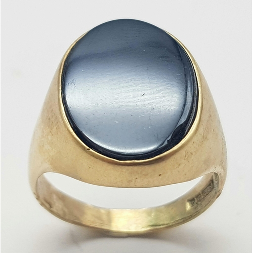 793 - A GENTS 9K GOLD SIGNET RING WITH BLACK ONYX OVAL STONE .    6.6gms   size T