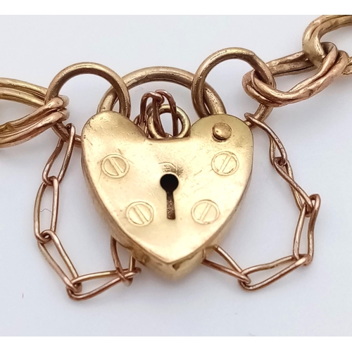 811 - A 9K GOLD INTERLINK BRACELET WITH HEART PADLOCK AND SAFETY CHAIN .   3.6gms   18cms