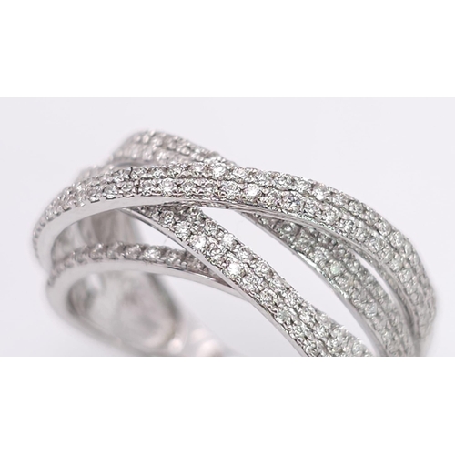 865 - A 9K White Gold Diamond Encrusted Orbital Ring. Eight lines of bright small round cut diamonds. Size... 