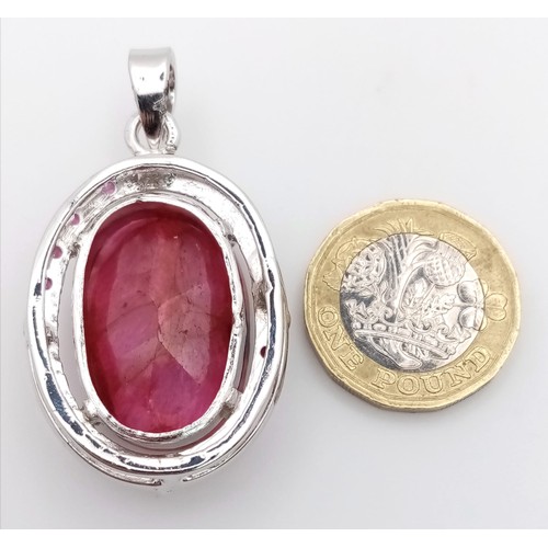 621 - A Ruby Oval Cut Pendant set in 925 Sterling silver. W- 20g. 70ct. 5cm. Comes with a presentation cas... 