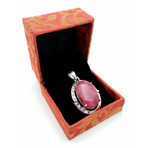 621 - A Ruby Oval Cut Pendant set in 925 Sterling silver. W- 20g. 70ct. 5cm. Comes with a presentation cas... 