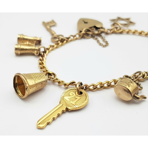 652 - A 9K GOLD CHARM BRACELET WITH 9 CHARMS TO INCLUDE A TANKARD, KETTLE ,KEY TO THE DOOR AMND MANY OTHER... 