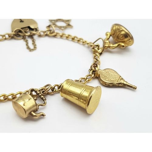 652 - A 9K GOLD CHARM BRACELET WITH 9 CHARMS TO INCLUDE A TANKARD, KETTLE ,KEY TO THE DOOR AMND MANY OTHER... 