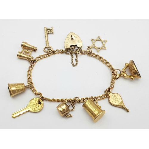 652 - A 9K GOLD CHARM BRACELET WITH 9 CHARMS TO INCLUDE A TANKARD, KETTLE ,KEY TO THE DOOR AMND MANY OTHER... 